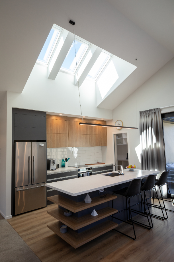 A kitchen ceiling with skylights bringing daylight onto the island bench