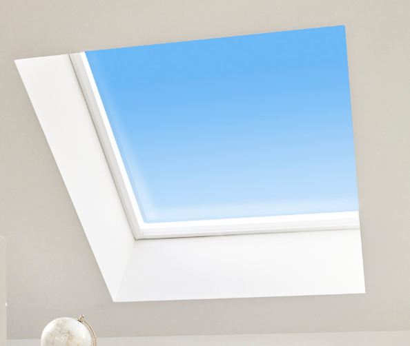 A single custom skylight set into a crisp white ceiling reveal with blue sky above